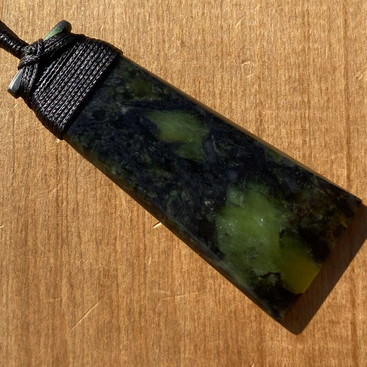Bound toki pendant hand-carved from New Zealand Douglas Creek pounamu (greenstone). Front.