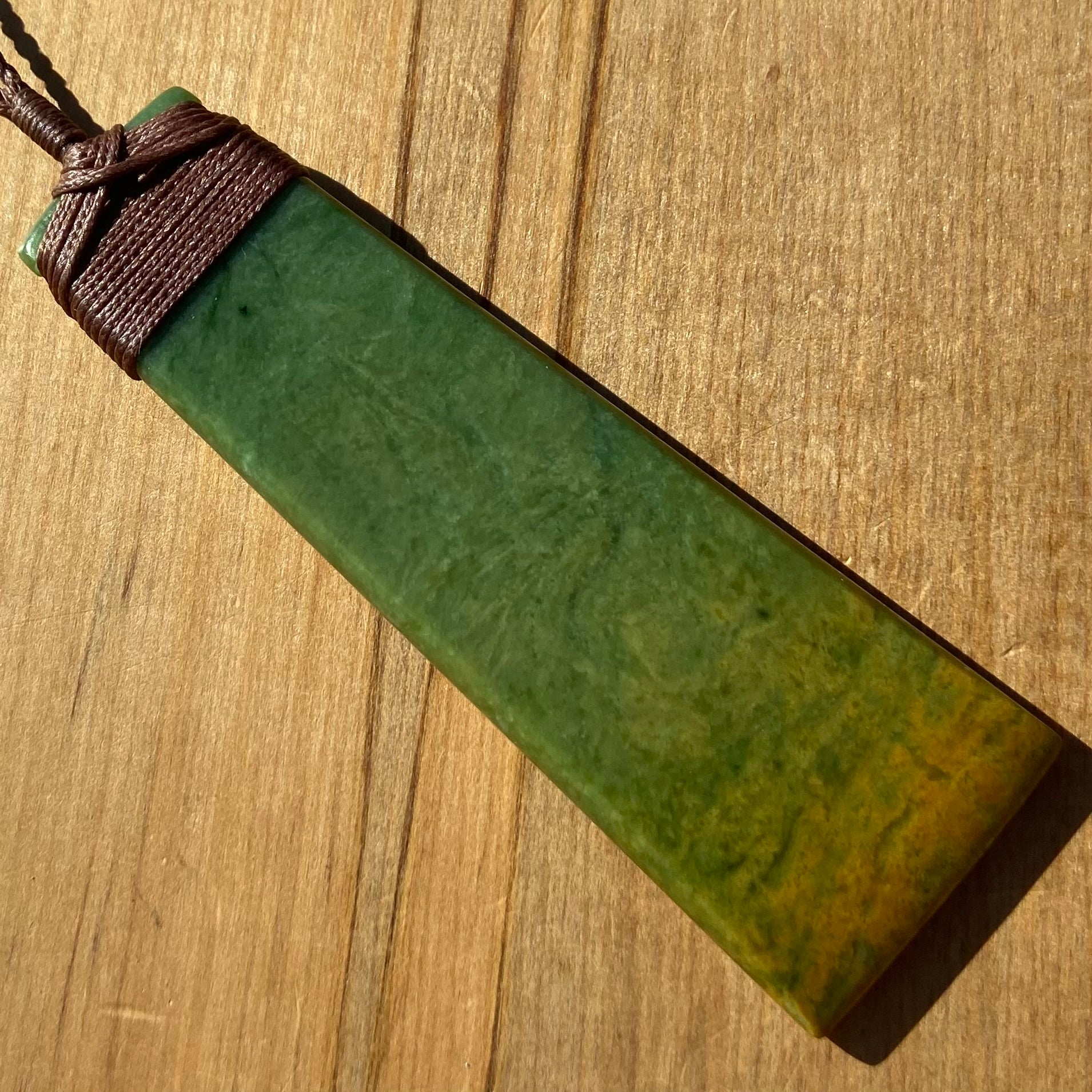Toki pendant hand-carved from New Zealand Marsden Flower Jade/ pounamu (greenstone). Front.
