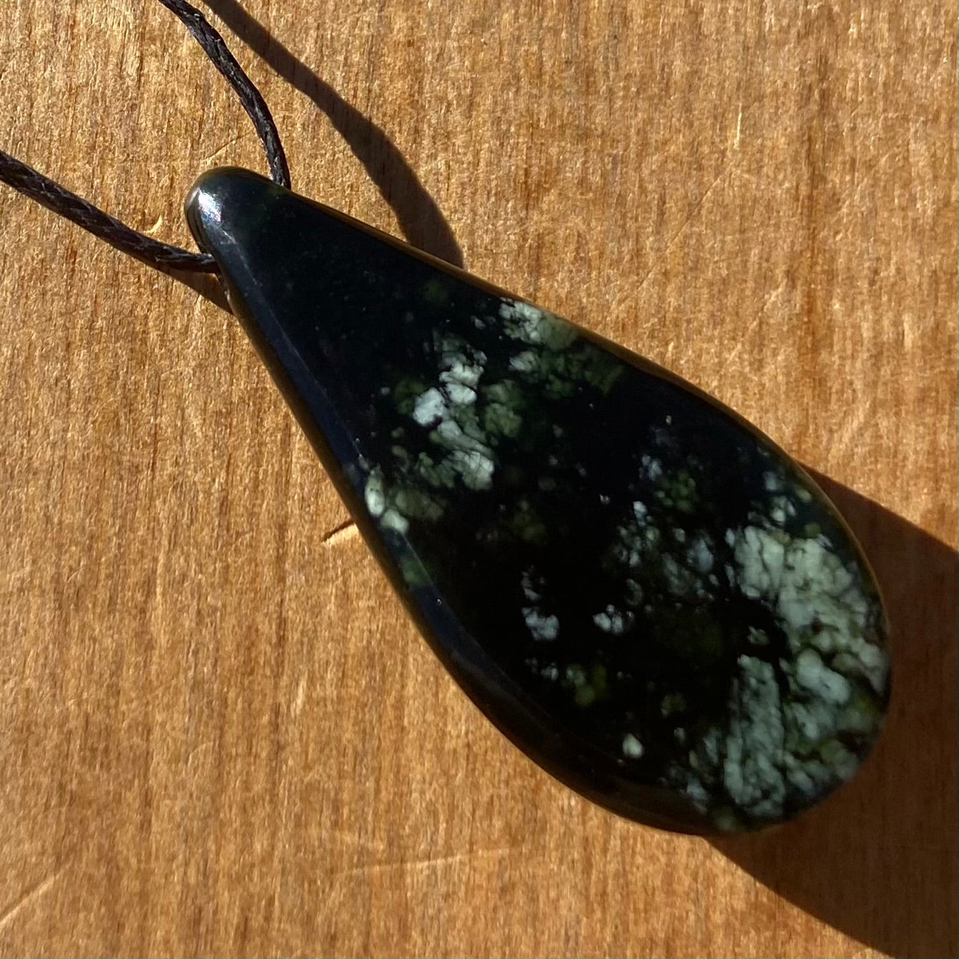 Roimata (teardrop) pendant hand-carved from New Zealand tangiwai pounamu (greenstone). Back.