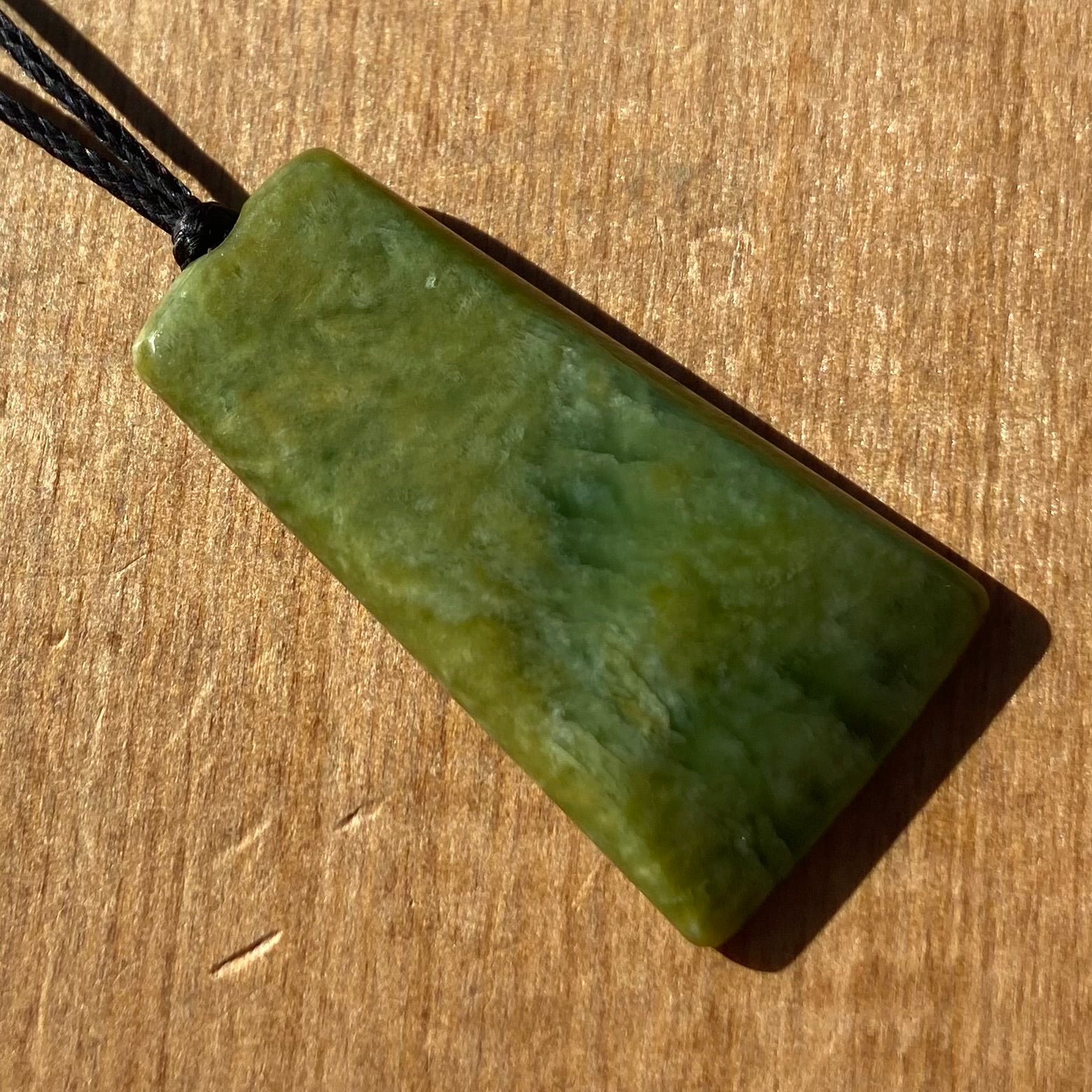 Pounamu toki pendant hand-carved from New Zealand Marsden Flower Jade pounamu (greenstone). Front