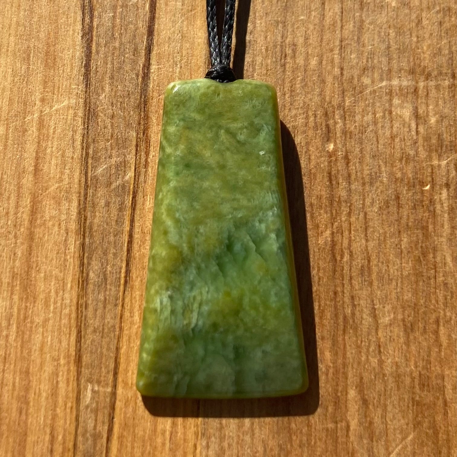 Pounamu toki pendant hand-carved from New Zealand Marsden Flower Jade pounamu (greenstone). Front