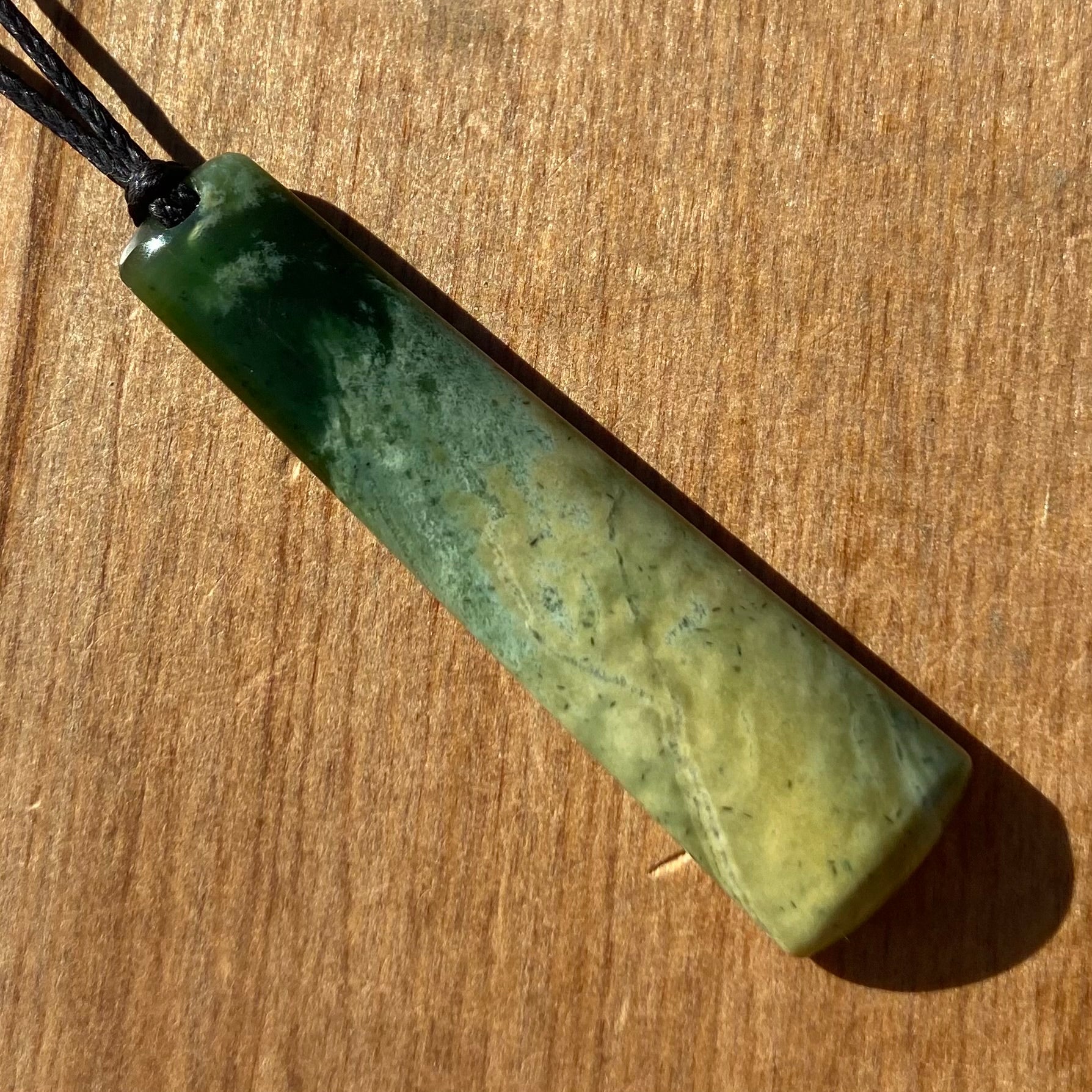 Pounamu toki pendant hand-carved from New Zealand Marsden Flower Jade pounamu (greenstone). Front