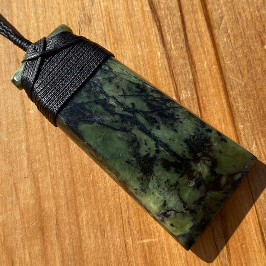Bound toki pendant hand-carved from New Zealand Douglas Creek pounamu (greenstone). Front.