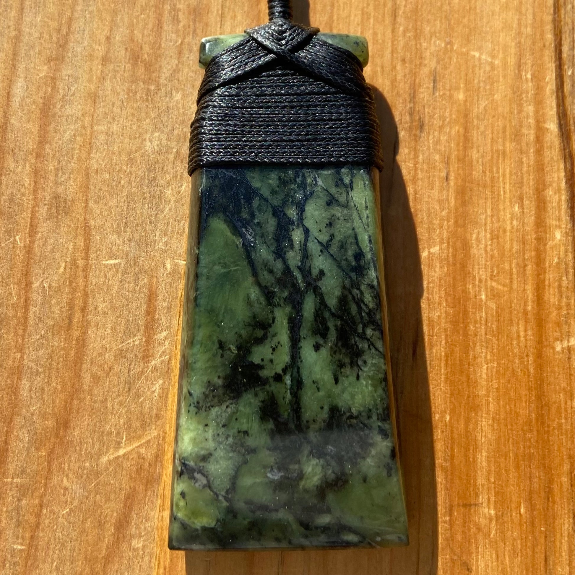 Bound toki pendant hand-carved from New Zealand Douglas Creek pounamu (greenstone). Front.