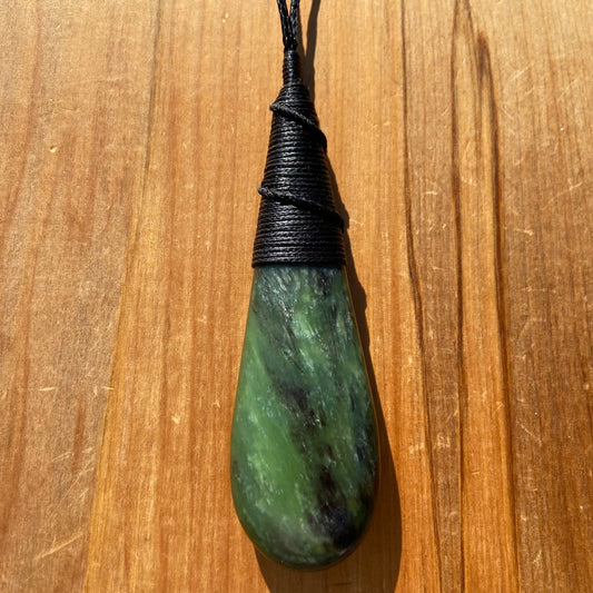 Bound roimata (teardrop) pendant hand-carved from New Zealand Kawakawa pounamu (greenstone). Front.