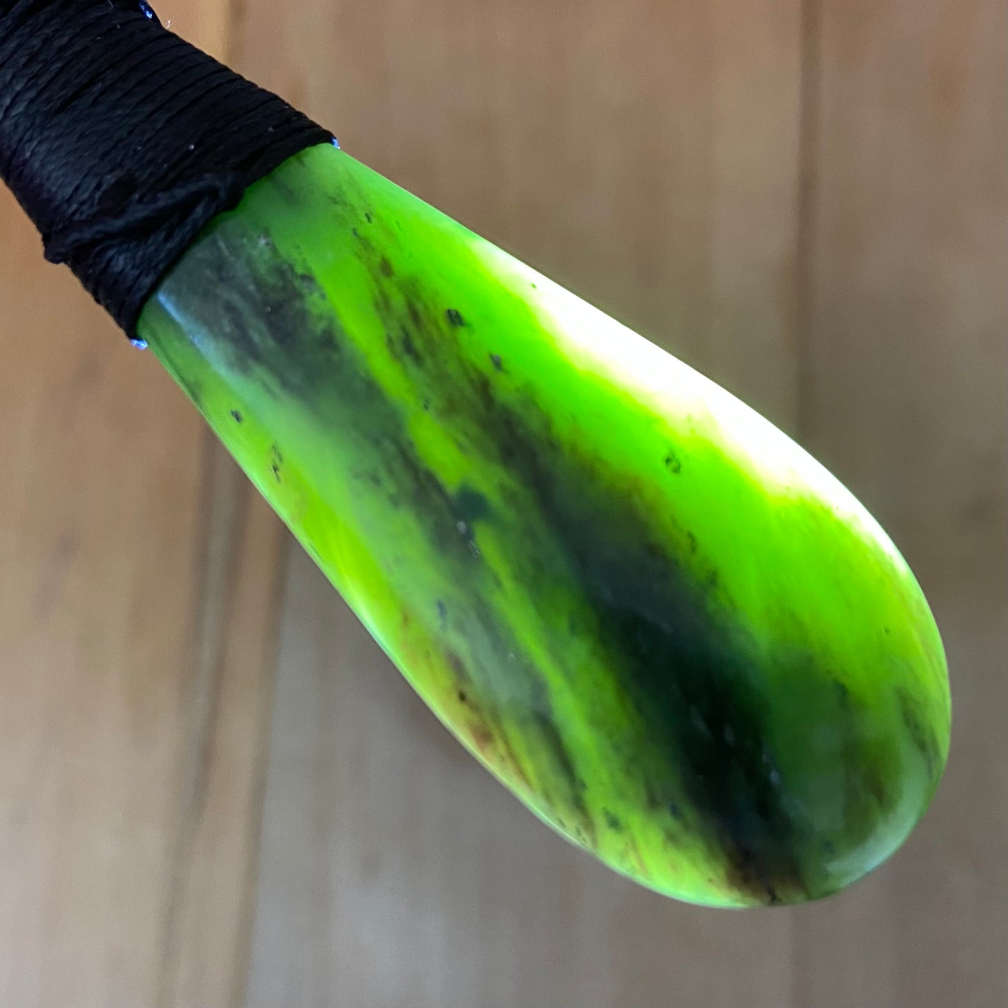 Bound roimata (teardrop) pendant hand-carved from New Zealand Kawakawa pounamu (greenstone). Translucency.