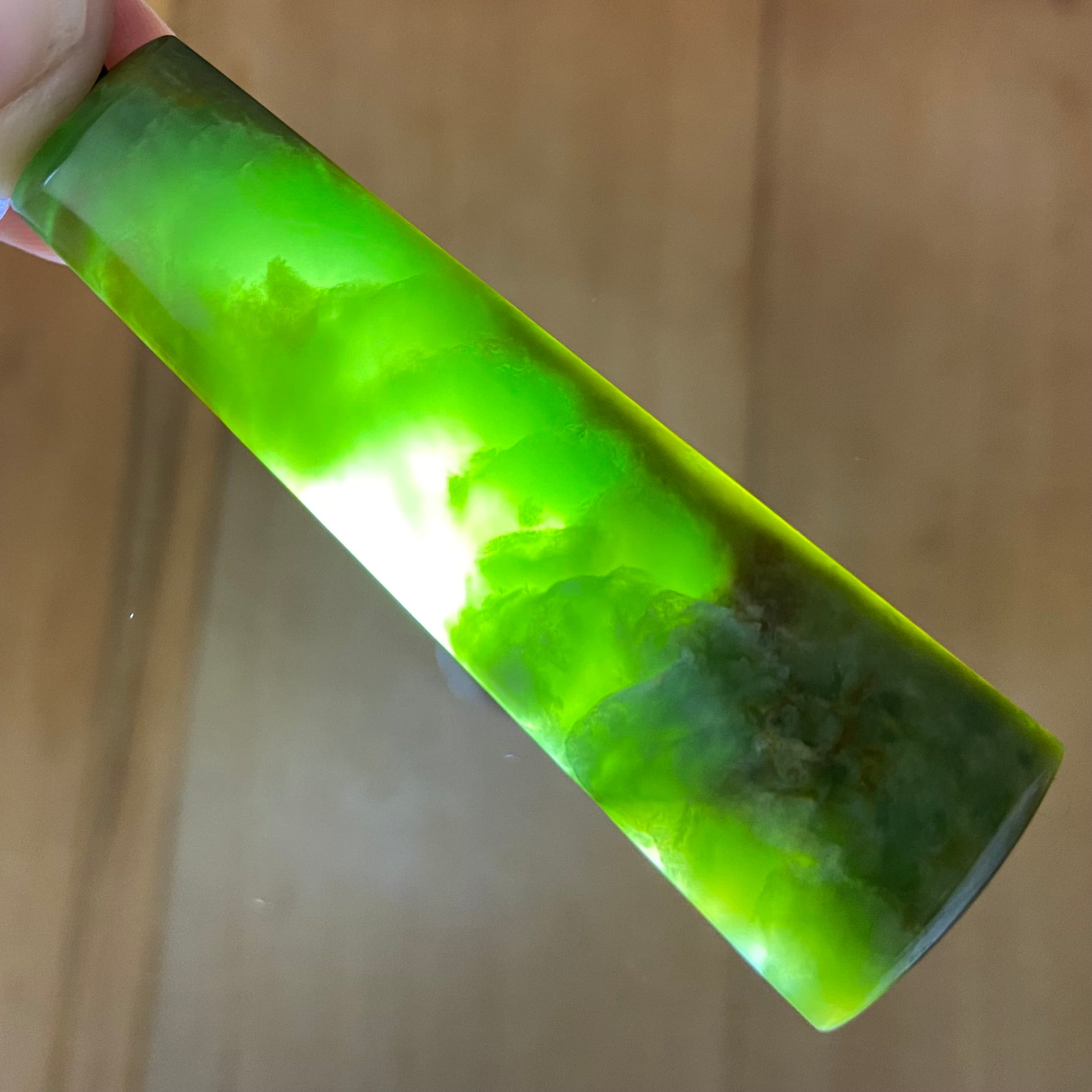 Pounamu toki pendant hand-carved from New Zealand Marsden Flower Jade pounamu (greenstone). Translucency.