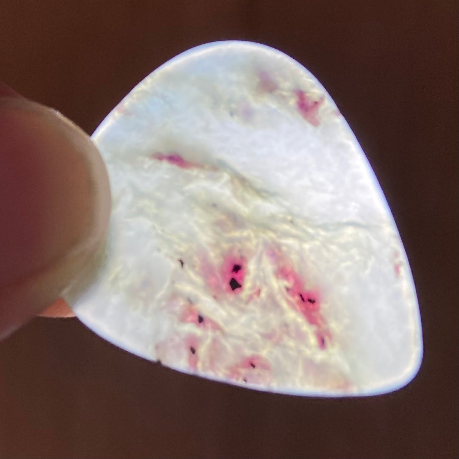 Guitar pick hand-carved from New Zealand Inanga Greenstone pounamu (greenstone). Translucency.