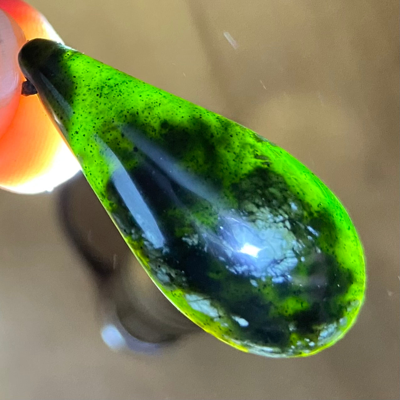 Roimata (teardrop) pendant hand-carved from New Zealand tangiwai pounamu (greenstone). Translucent.