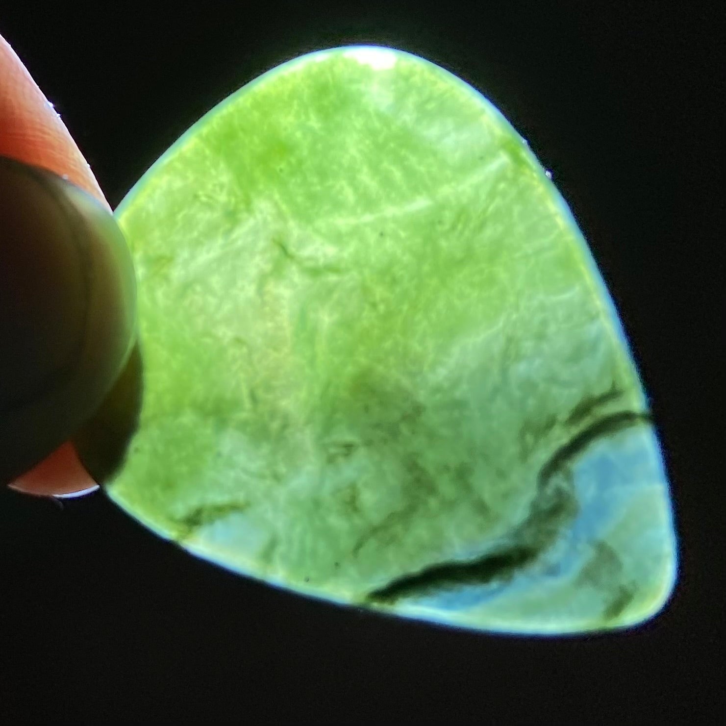 Guitar pick hand-carved from New Zealand Kawakawa Greenstone pounamu (greenstone). Translucency.