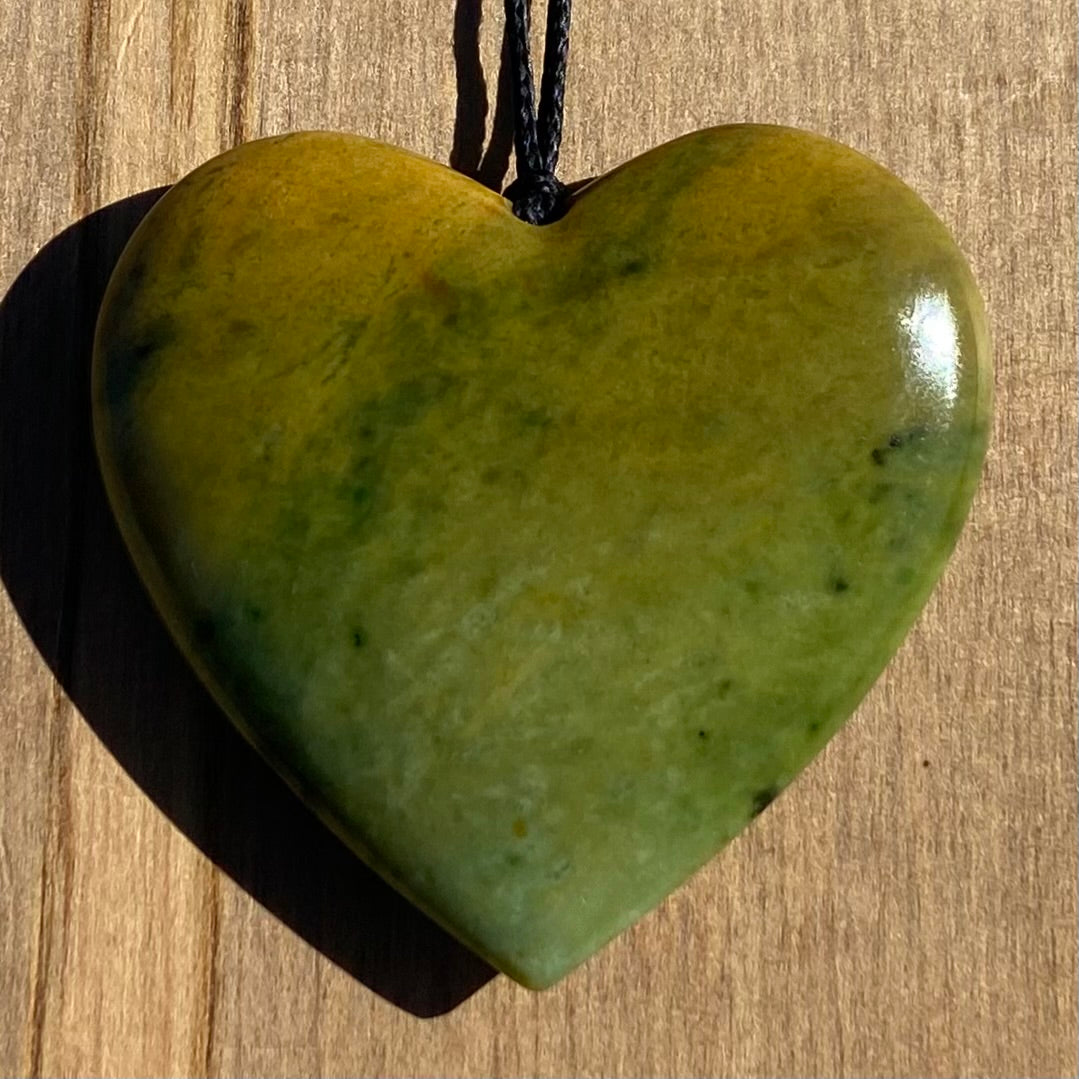 Heart shape pendant carved from New Zealand Marsden Flower Jade (greenstone). Front.