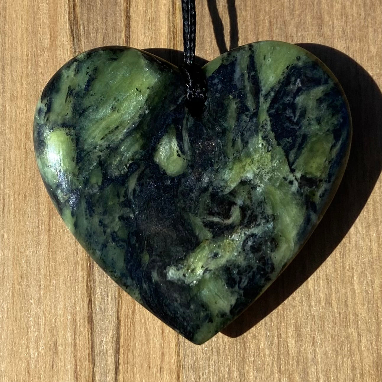 Heart shape pendant carved from New Zealand Douglas Creek pounamu (greenstone). Back.