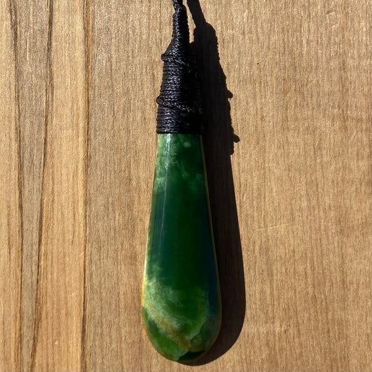 Bound roimata teardrop pendant carved from New Zealand Marsden Flower Jade (greenstone). Front.