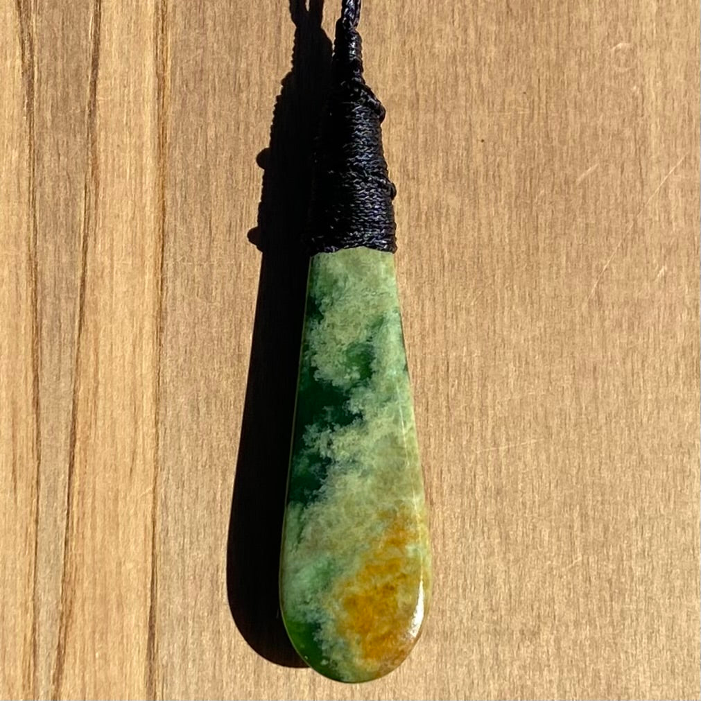 Bound roimata teardrop pendant carved from New Zealand Marsden Flower Jade (greenstone). Back.