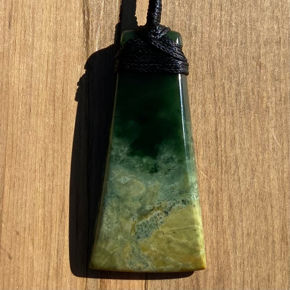 Bound toki pendant hand-carved from New Zealand Marsden Flower Jade pounamu (greenstone). Front