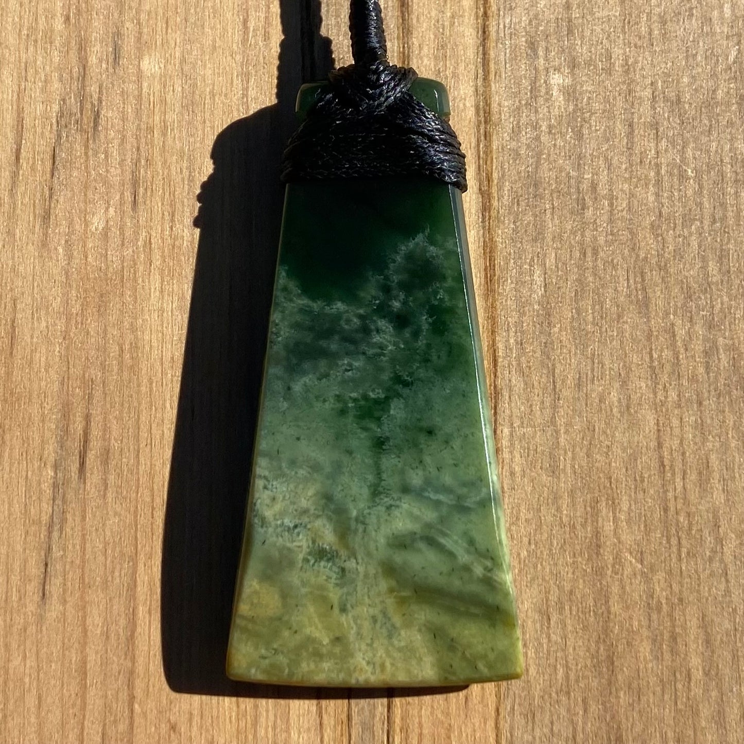 Bound toki pendant hand-carved from New Zealand Marsden Flower Jade pounamu (greenstone). Back.