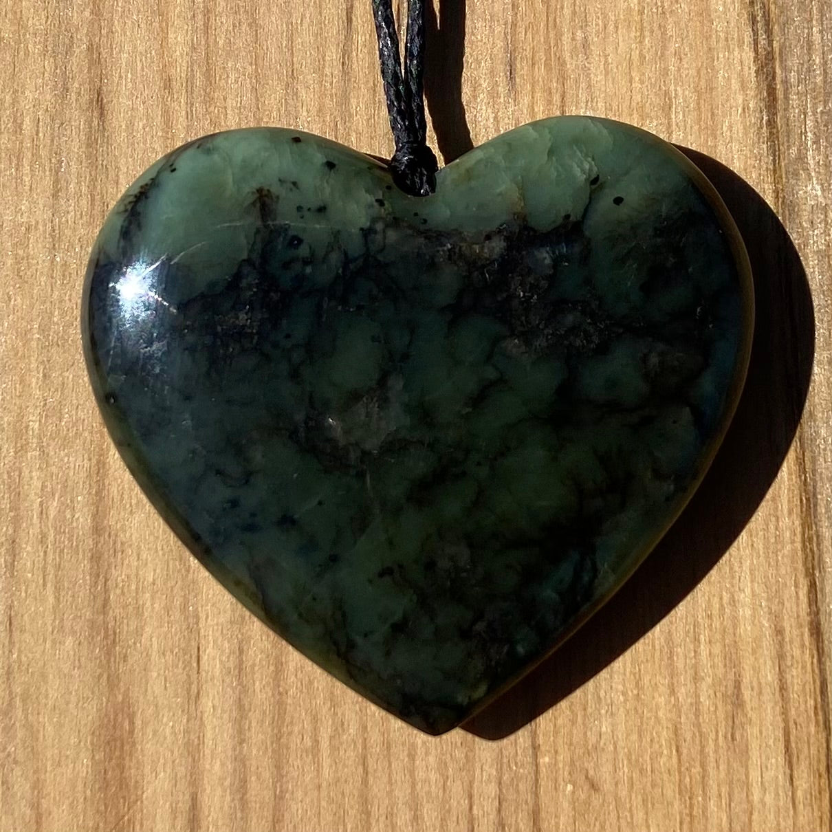 Heart pendant hand-carved from New Zealand Kawakawa pounamu (greenstone). Front