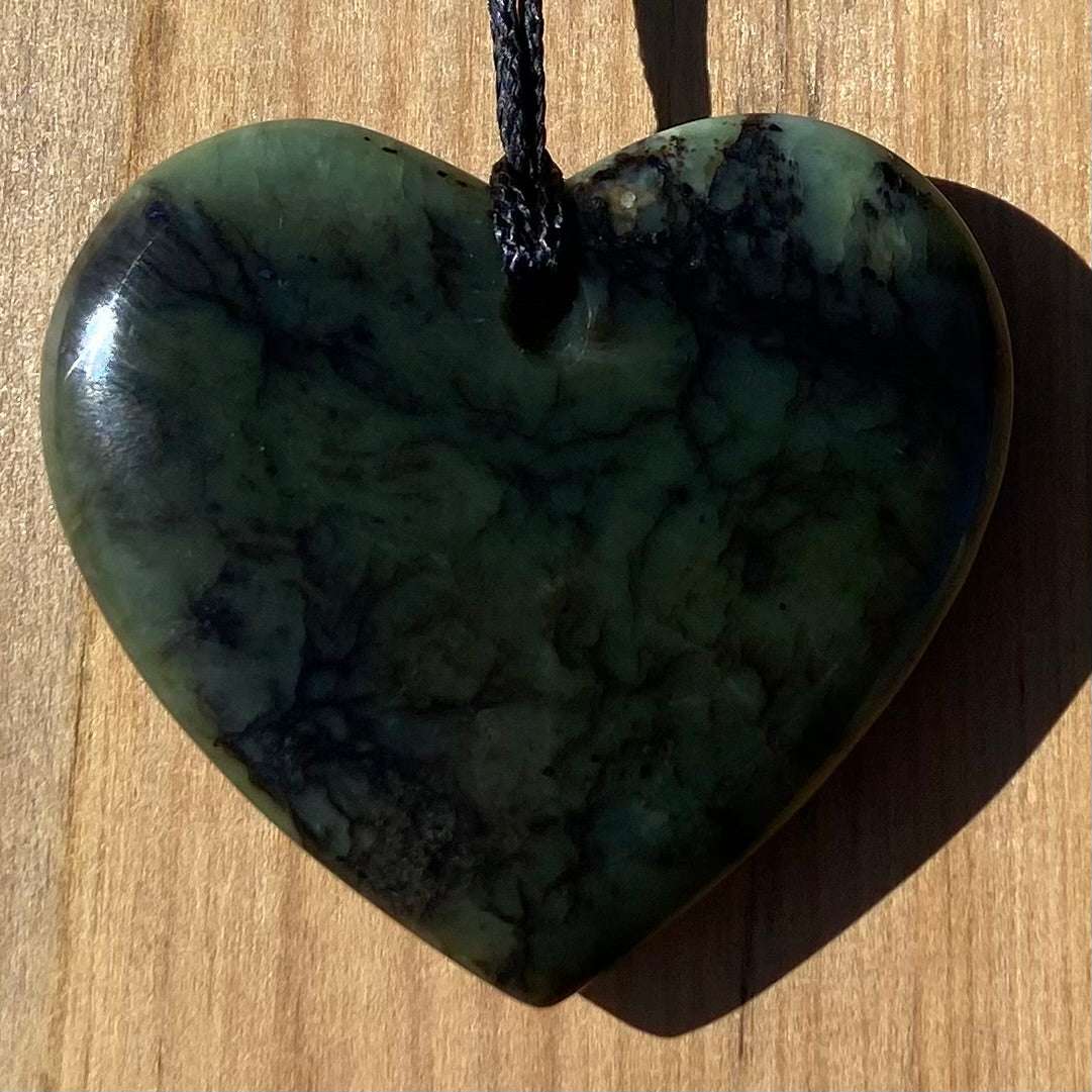 Heart pendant hand-carved from New Zealand Kawakawa pounamu (greenstone). Back.