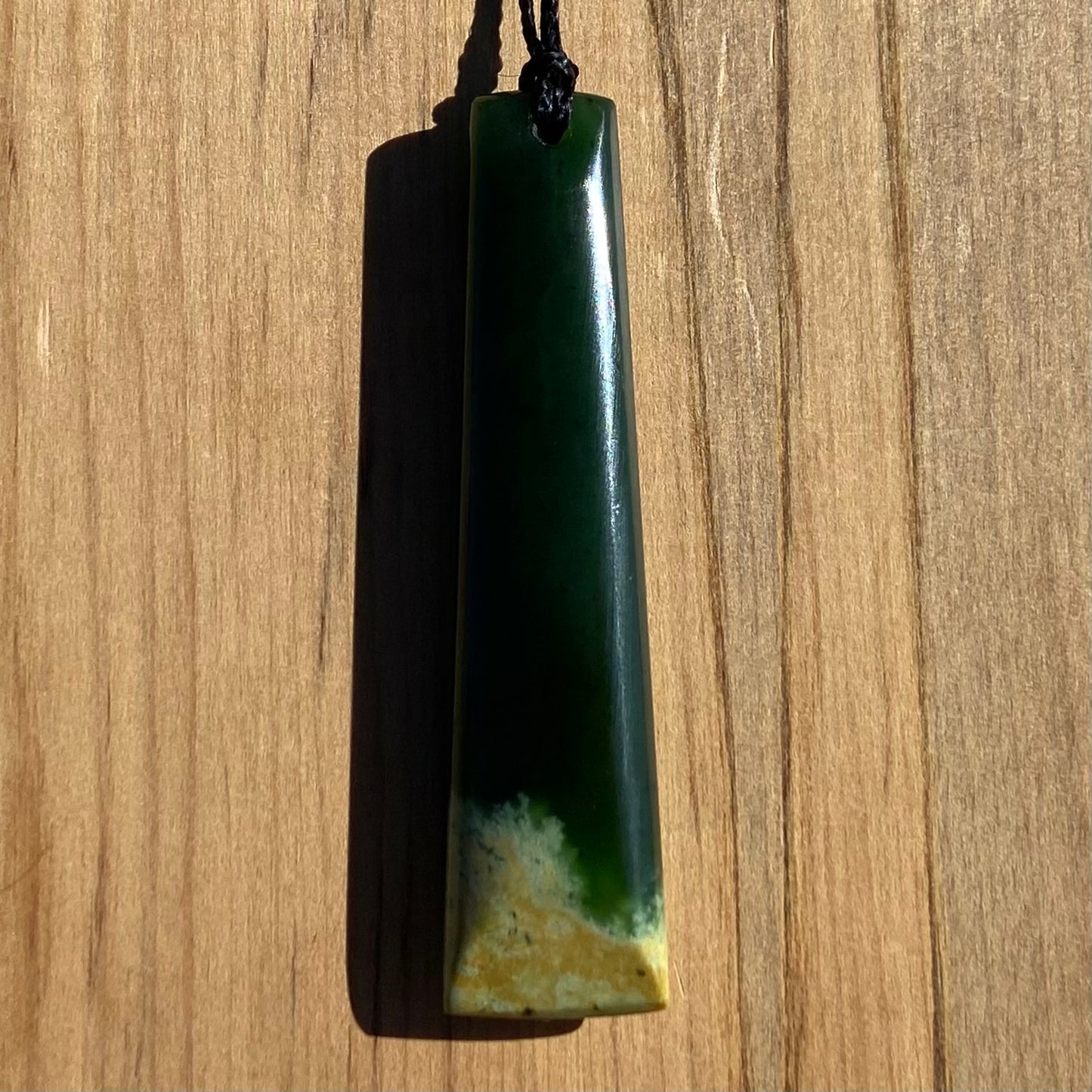 Bound toki pendant hand-carved from New Zealand Marsden Flower Jade pounamu (greenstone). Back.