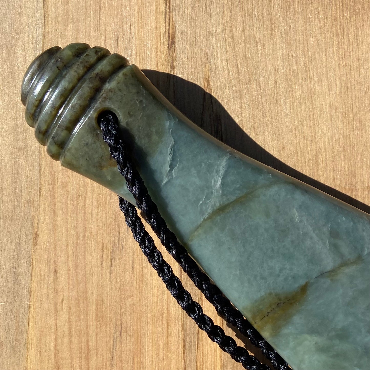 Pounamu mere hand-carved from South Westland Inanga pounamu (greenstone). Handle.