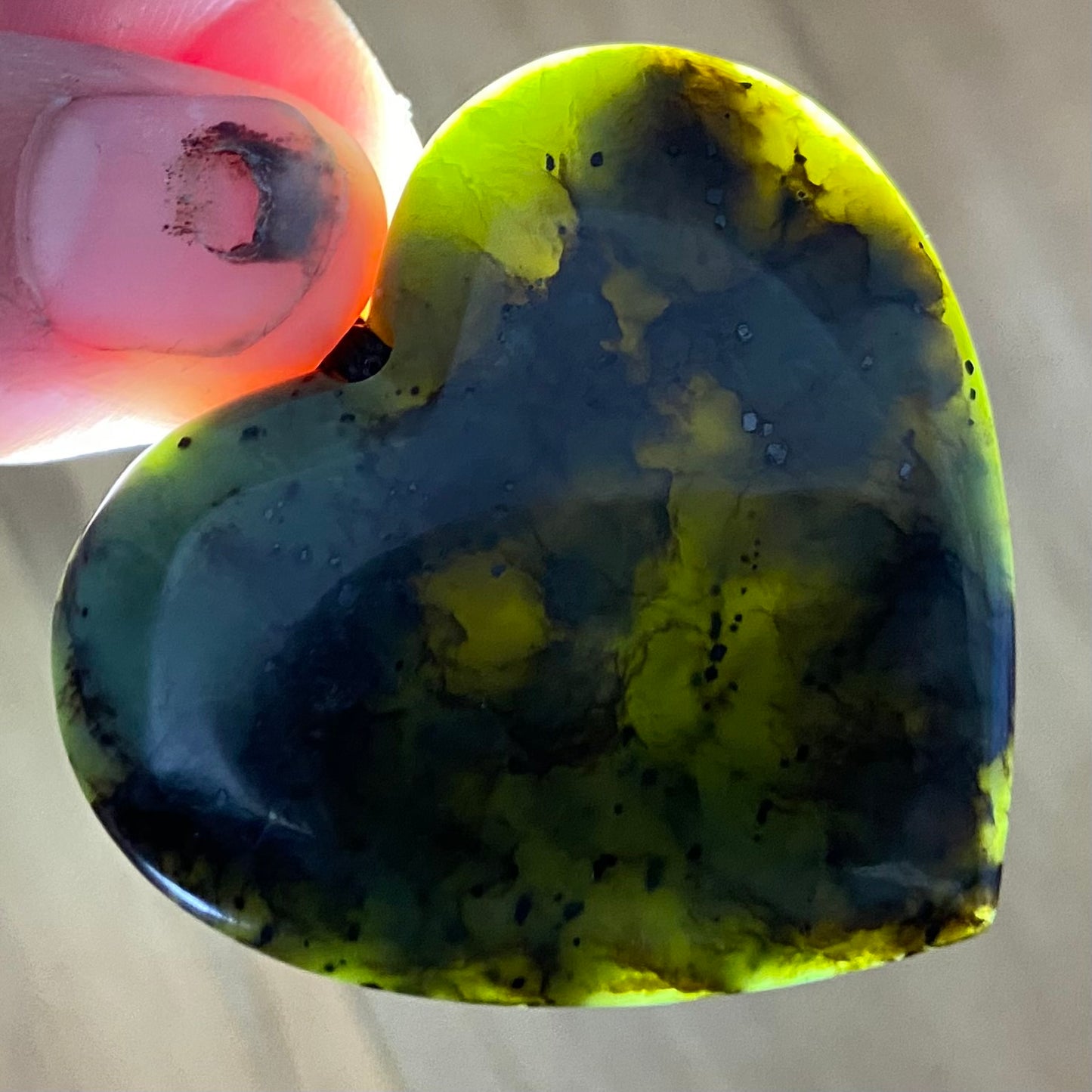 Heart pendant hand-carved from New Zealand Kawakawa pounamu (greenstone). Translucency