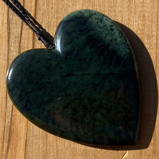 Pounamu heart pendant hand-carved from New Zealand kawawkawa pounamu (greenstone). Front.