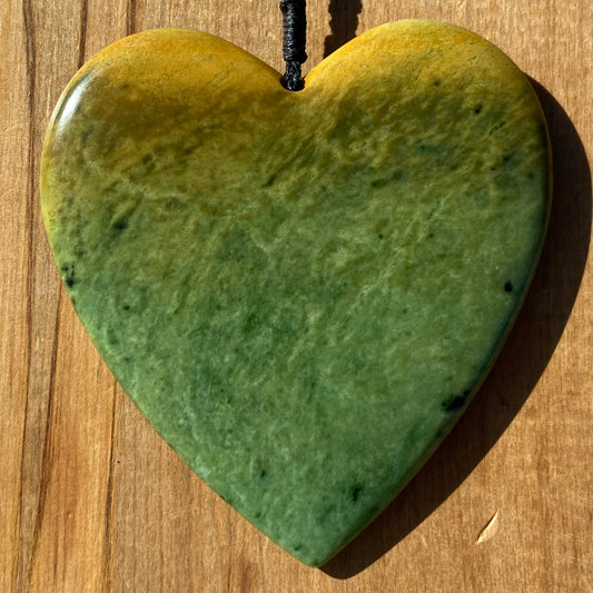 Pounamu heart shape pendant carved from New Zealand Marsden Flower Jade (greenstone). Front. Large