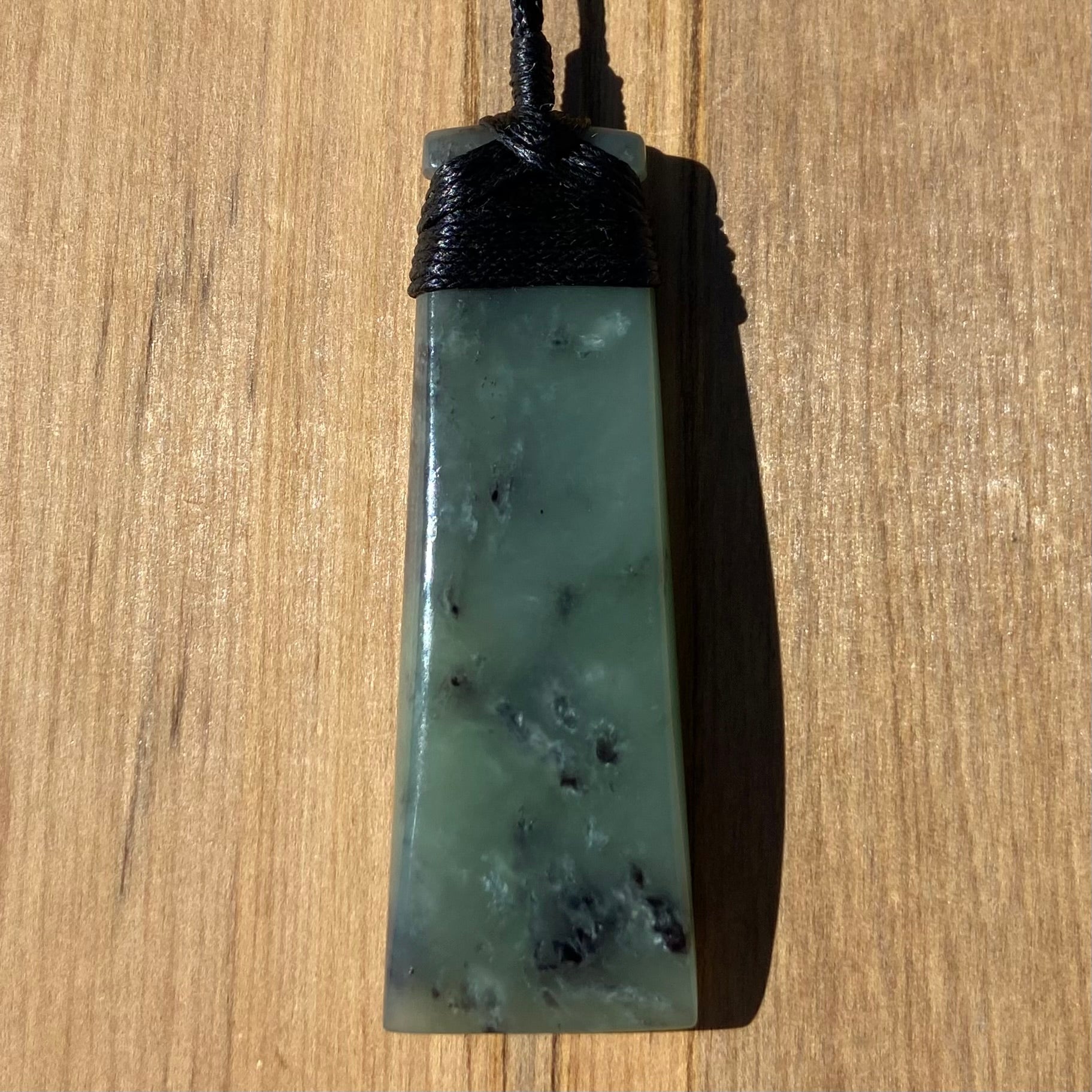 Bound toki pendant hand-carved from New Zealand inanga pounamu (greenstone). Front.