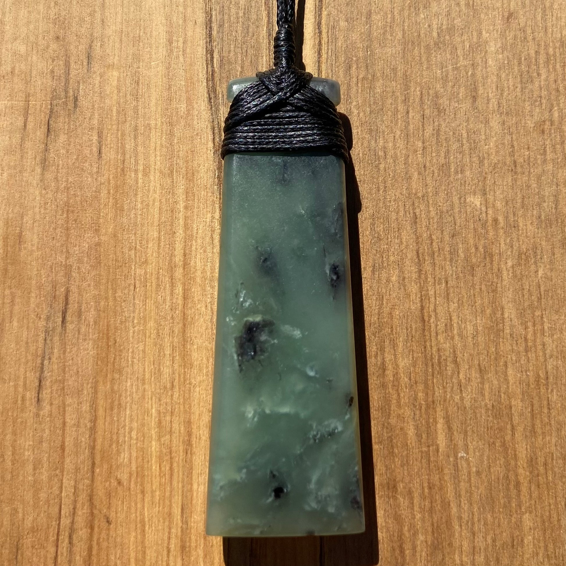 Bound toki pendant hand-carved from New Zealand inanga pounamu (greenstone). Back.