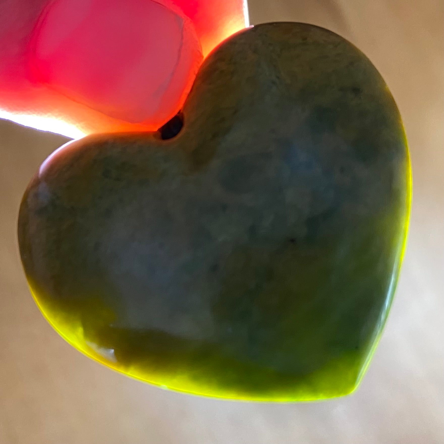 Heart shape pendant carved from New Zealand Marsden Flower Jade (greenstone). Translucency.