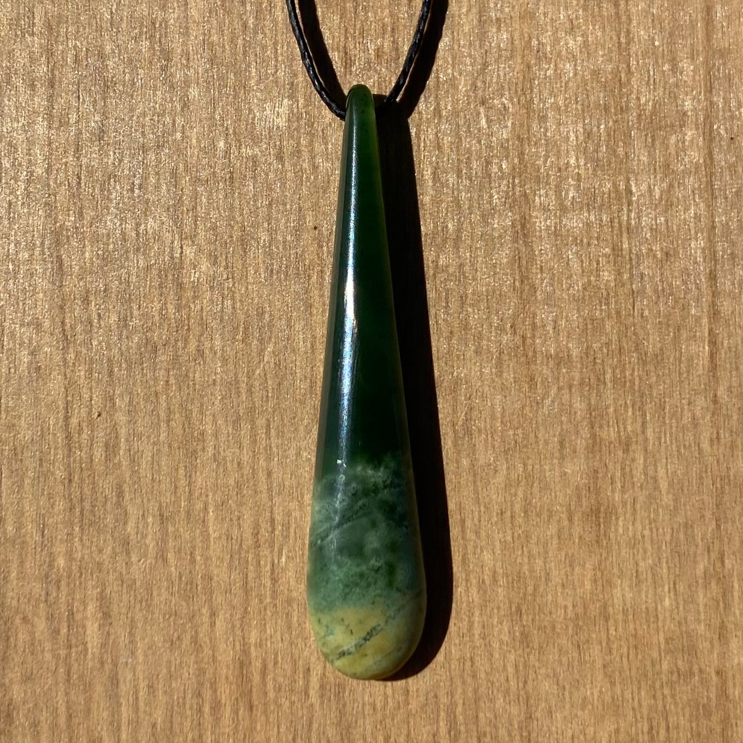 Roimata (teardrop) pendant hand-carved from New Zealand Marsden Flower Jade/ pounamu (greenstone). Front.