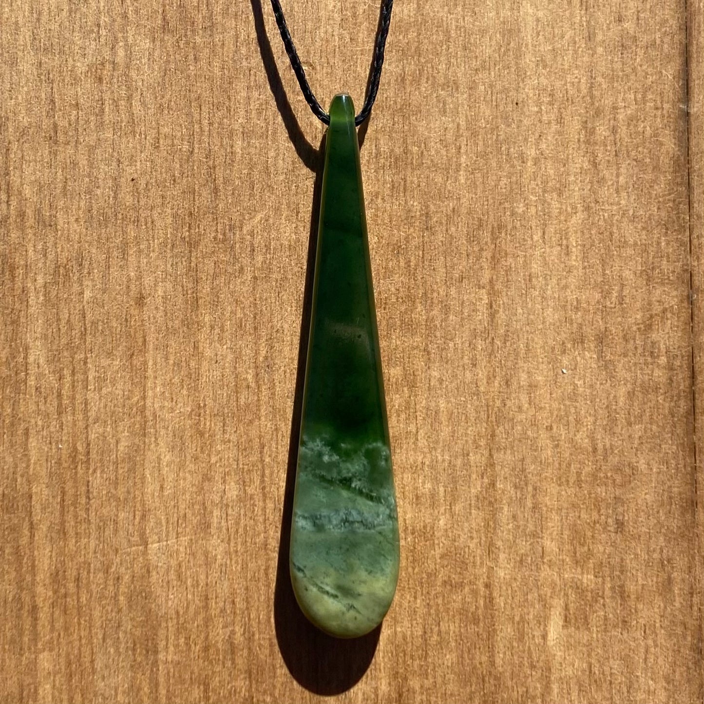 Roimata (teardrop) pendant hand-carved from New Zealand Marsden Flower Jade/ pounamu (greenstone). Back.