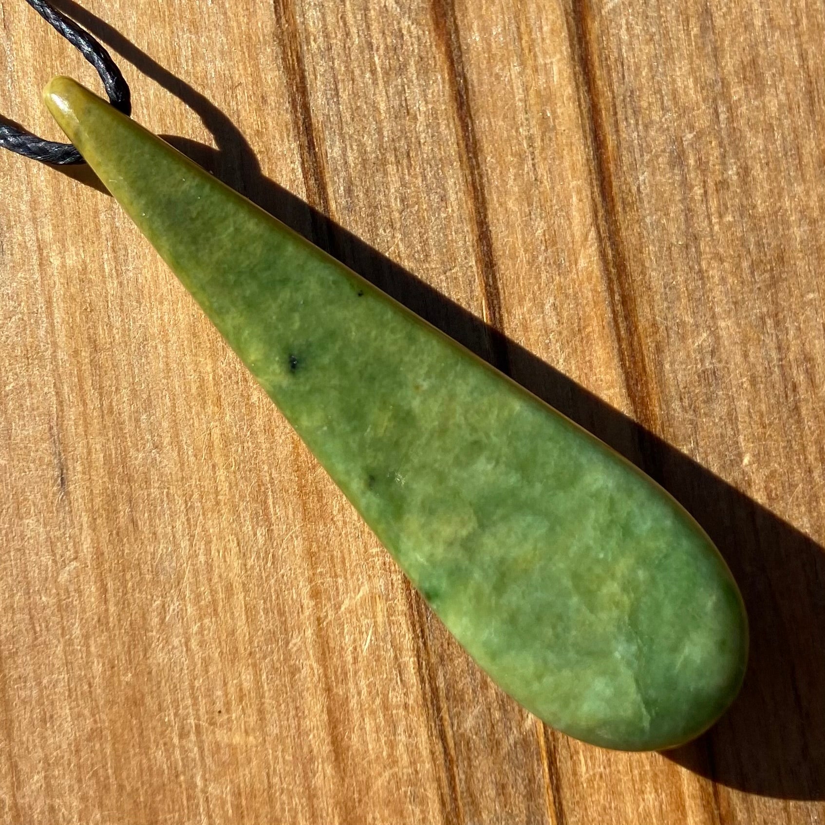Roimata (teardrop) pendant hand-carved from New Zealand Marsden Flower Jade/ pounamu (greenstone). Back.