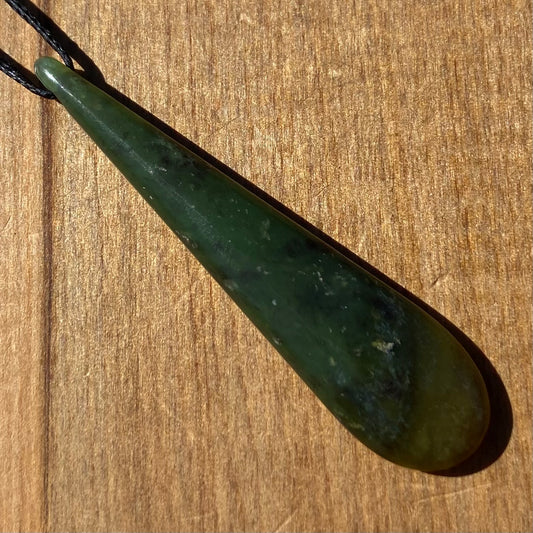 Roimata pendant hand-carved from New Zealand kawawkawa pounamu (greenstone). Front.