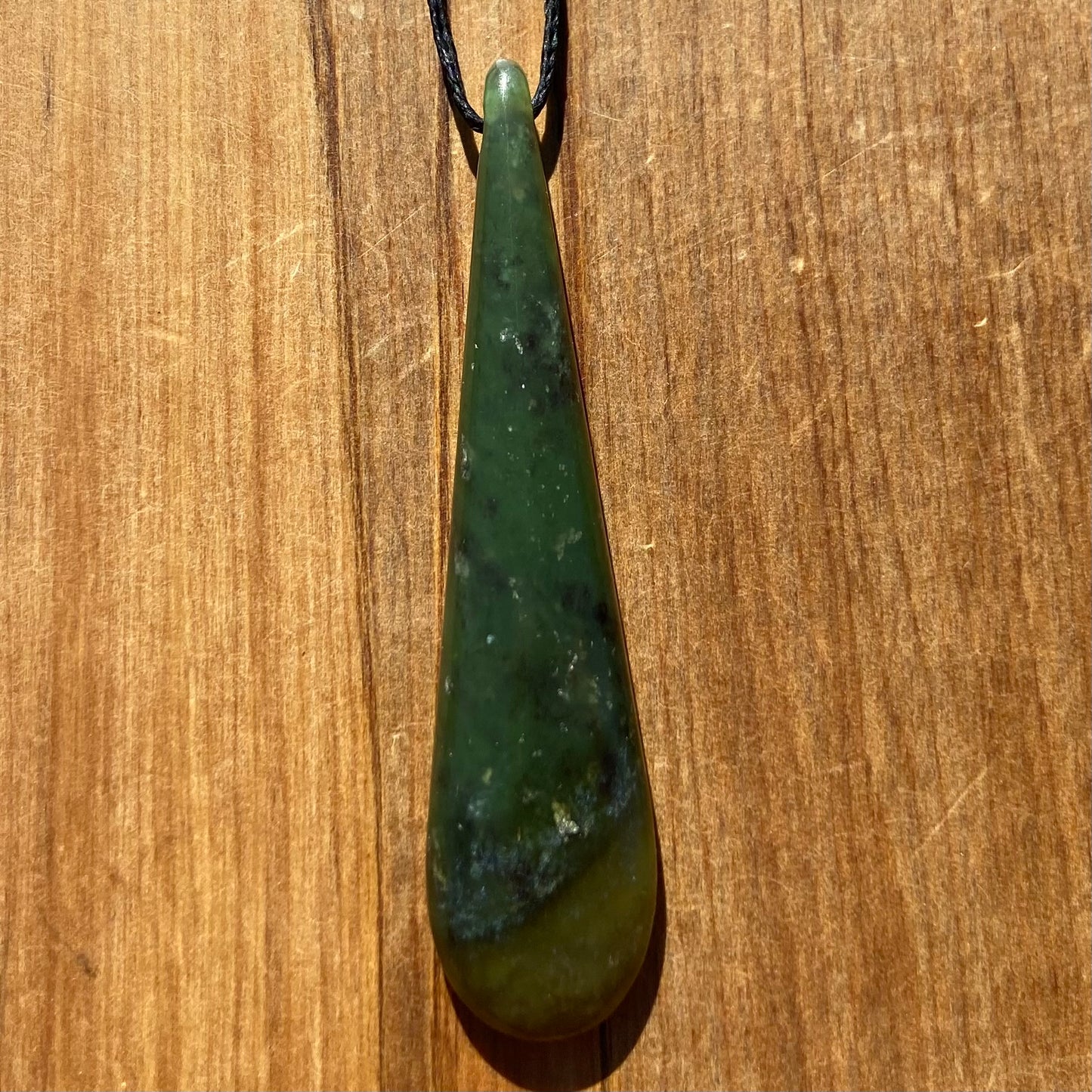 Roimata pendant hand-carved from New Zealand kawawkawa pounamu (greenstone). Front.