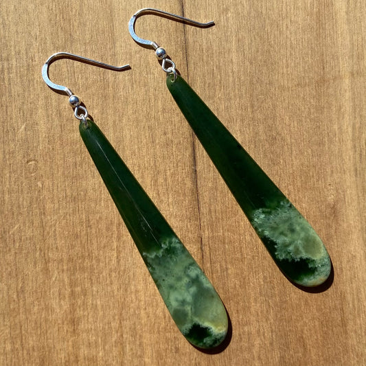 Pair of roimata (teardrop) earrings hand-carved from New Zealand Marsden Flower Jade/ pounamu (greenstone), with sterling silver fittings. Front.