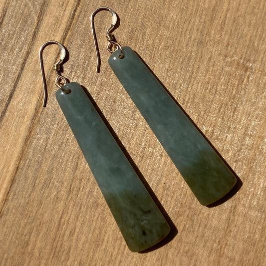 Roimata (teardrop) earrings hand-carved from New Zealand inanga pounamu (greenstone), with sterling silver fittings. Front.