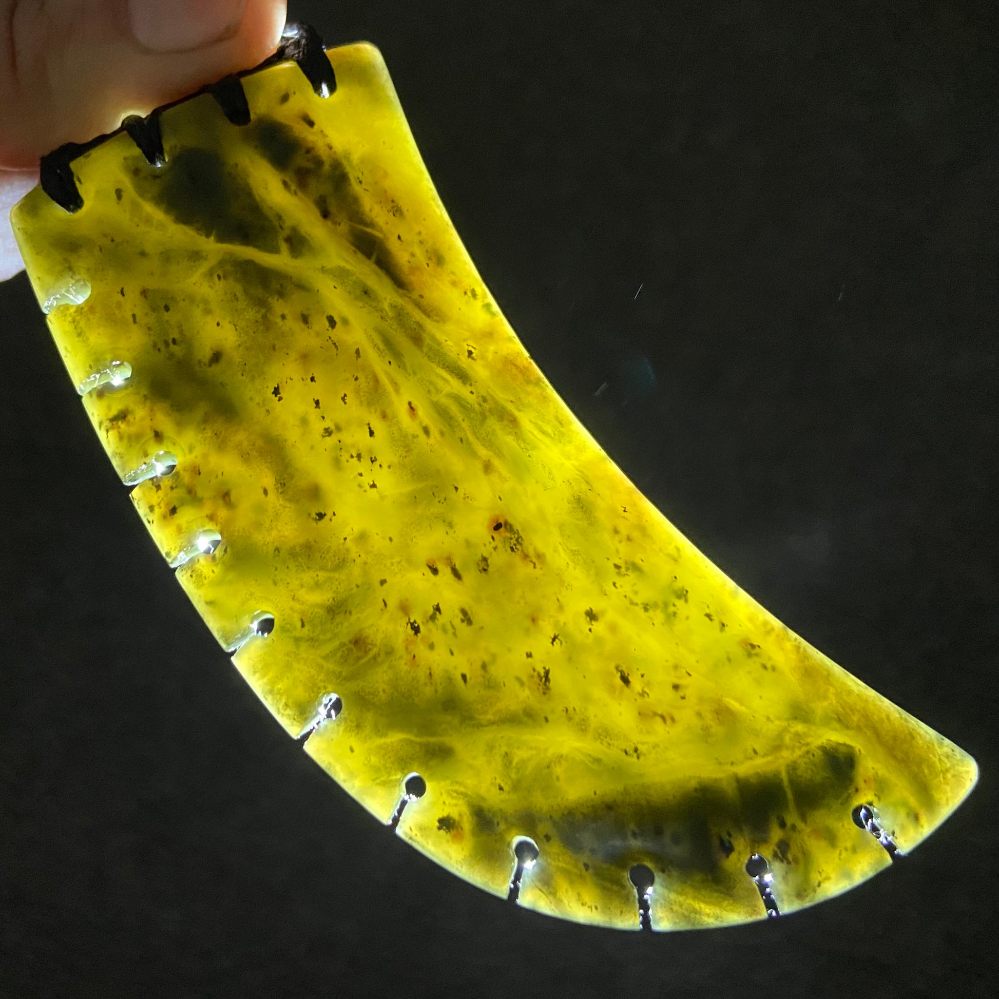 XL Bound Niho Tooth pendant hand-carved from New Zealand Kawakawa pounamu (greenstone). Translucency.