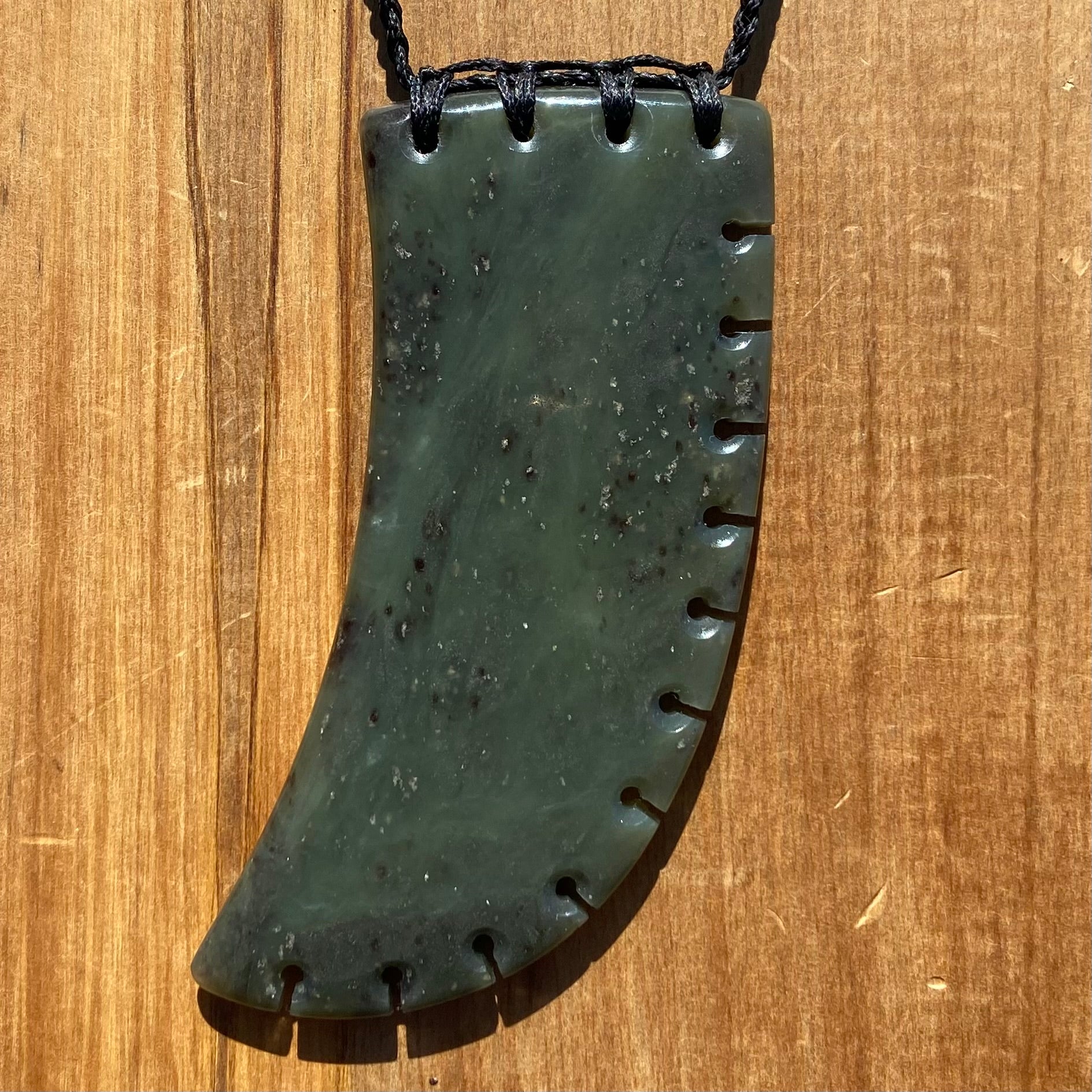 XL Bound Niho Tooth pendant hand-carved from New Zealand Kawakawa pounamu (greenstone). Front.