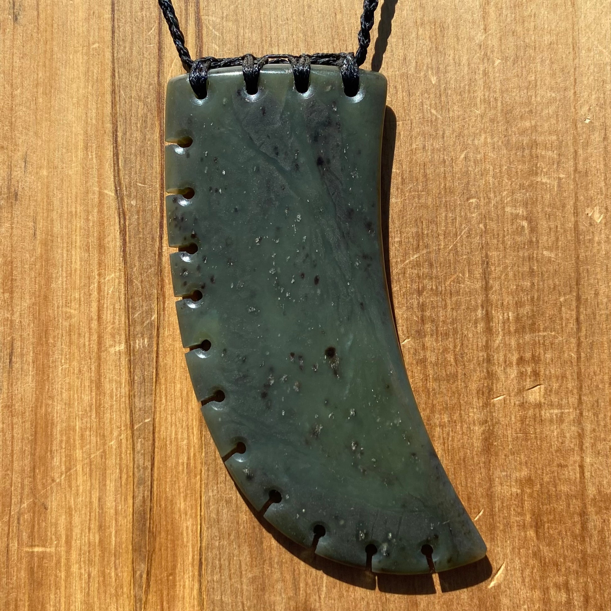 XL Bound Niho Tooth pendant hand-carved from New Zealand Kawakawa pounamu (greenstone). Front.