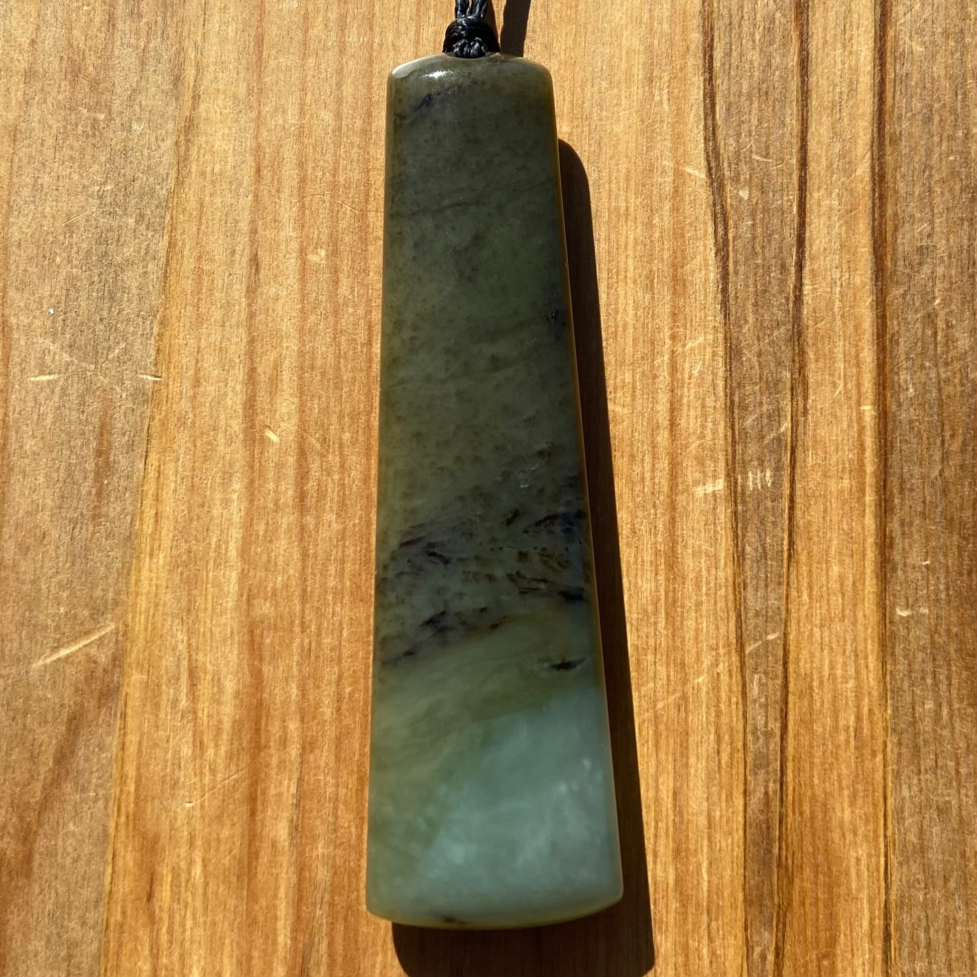 Toki pendant hand-carved from New Zealand inanga pounamu (greenstone). Front.