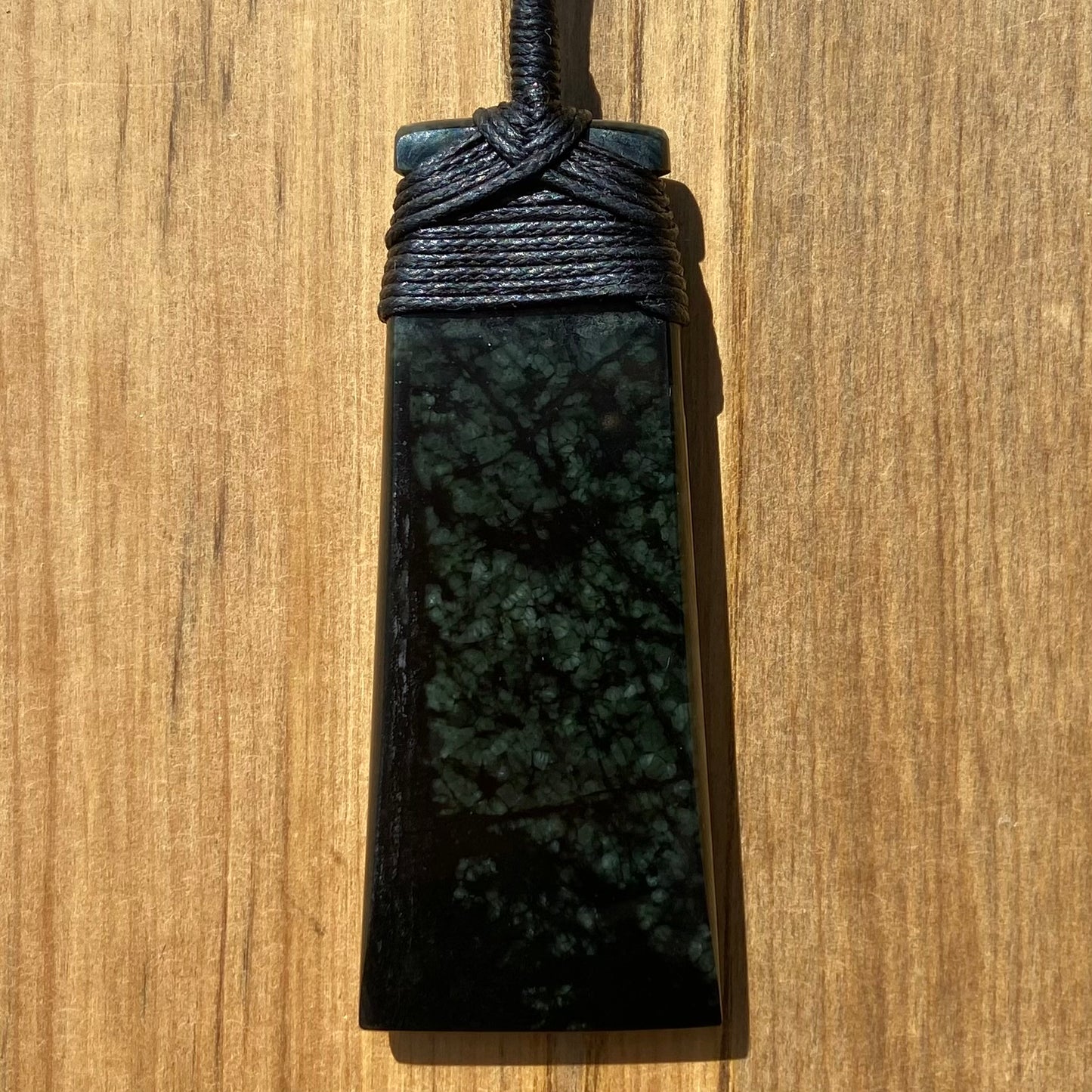 Bound toki pendant hand-carved from New Zealand tangiwai pounamu (greenstone). Back.