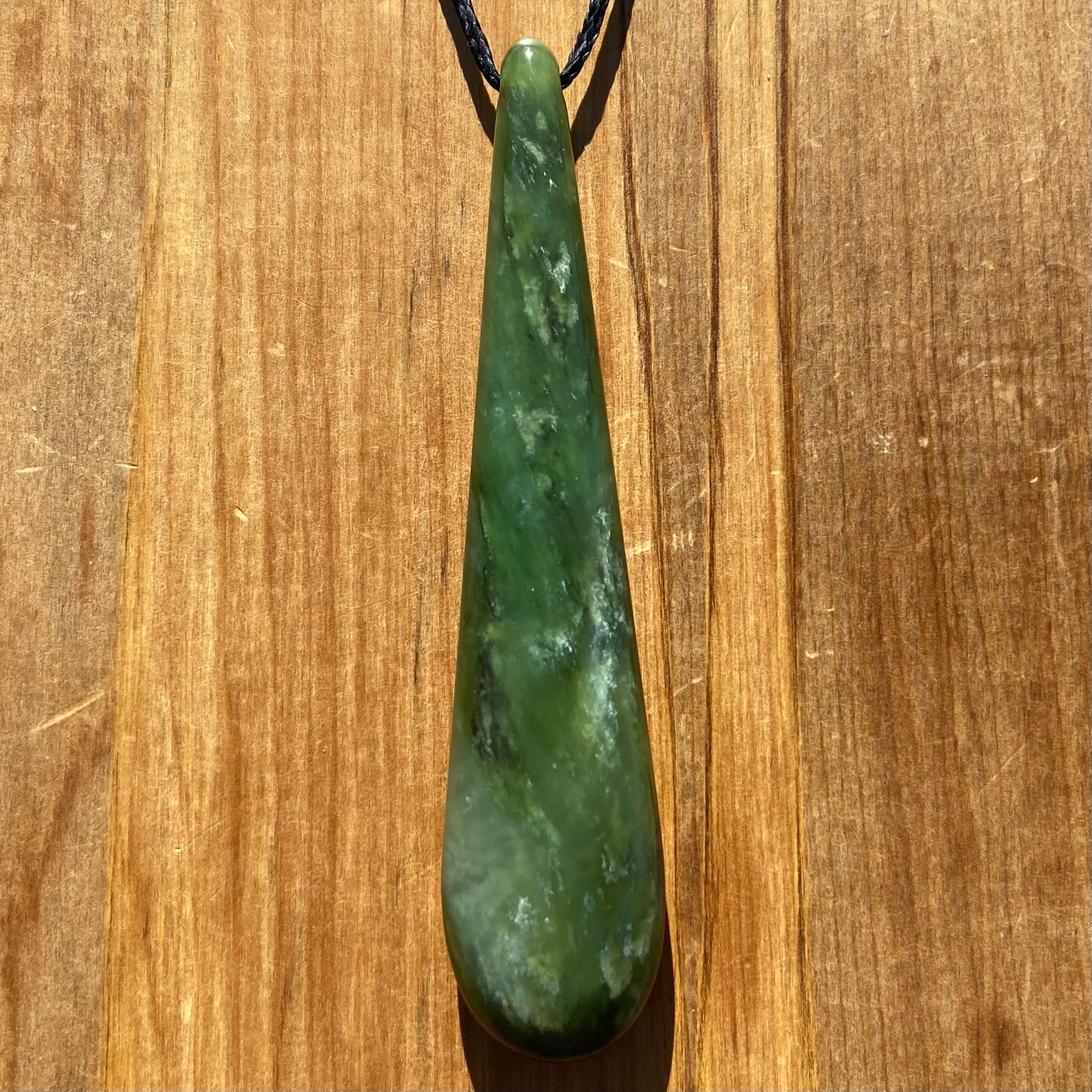 Roimata teardrop pendant hand-carved from New Zealand kawawkawa pounamu (greenstone). Front.