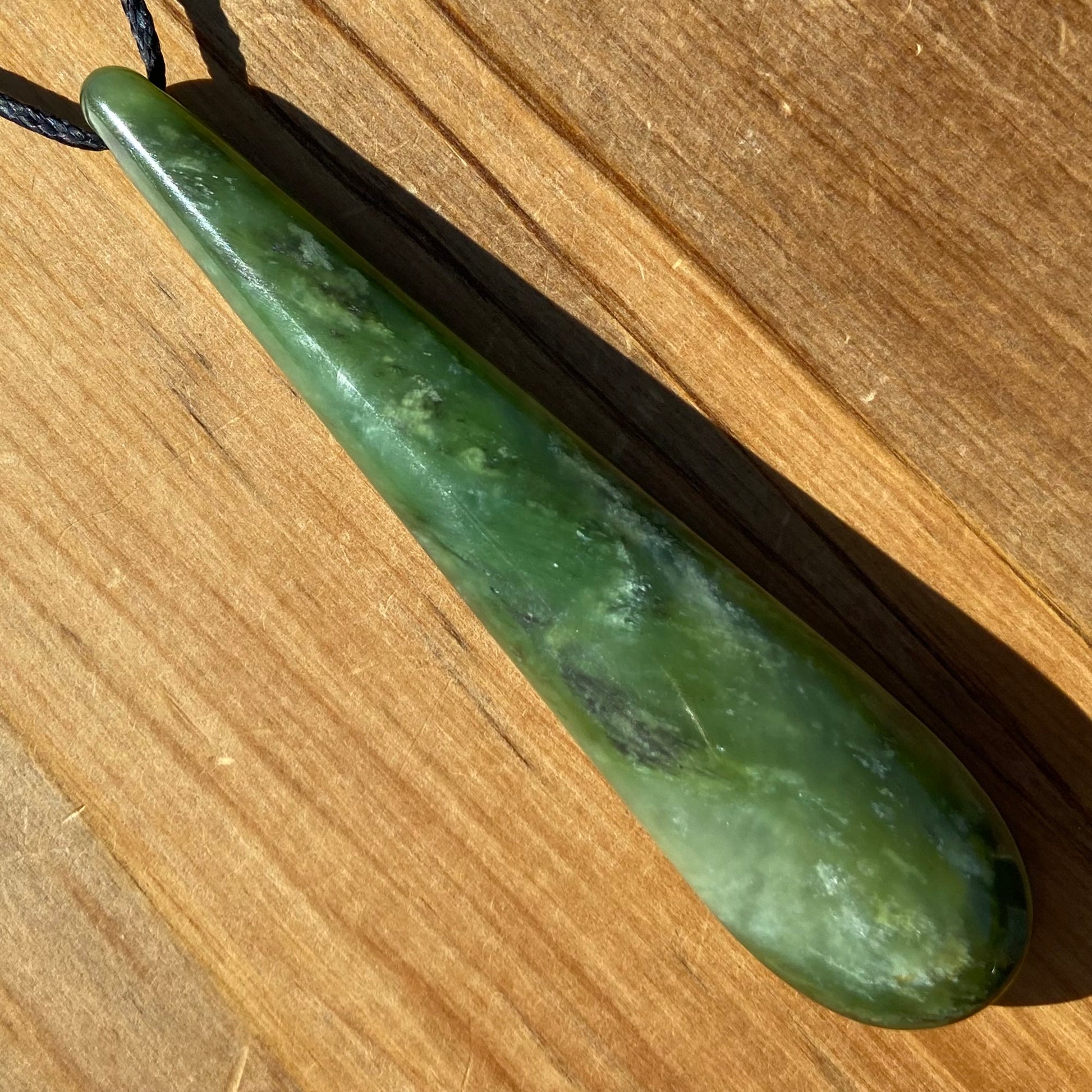 Roimata teardrop pendant hand-carved from New Zealand kawawkawa pounamu (greenstone). Front.