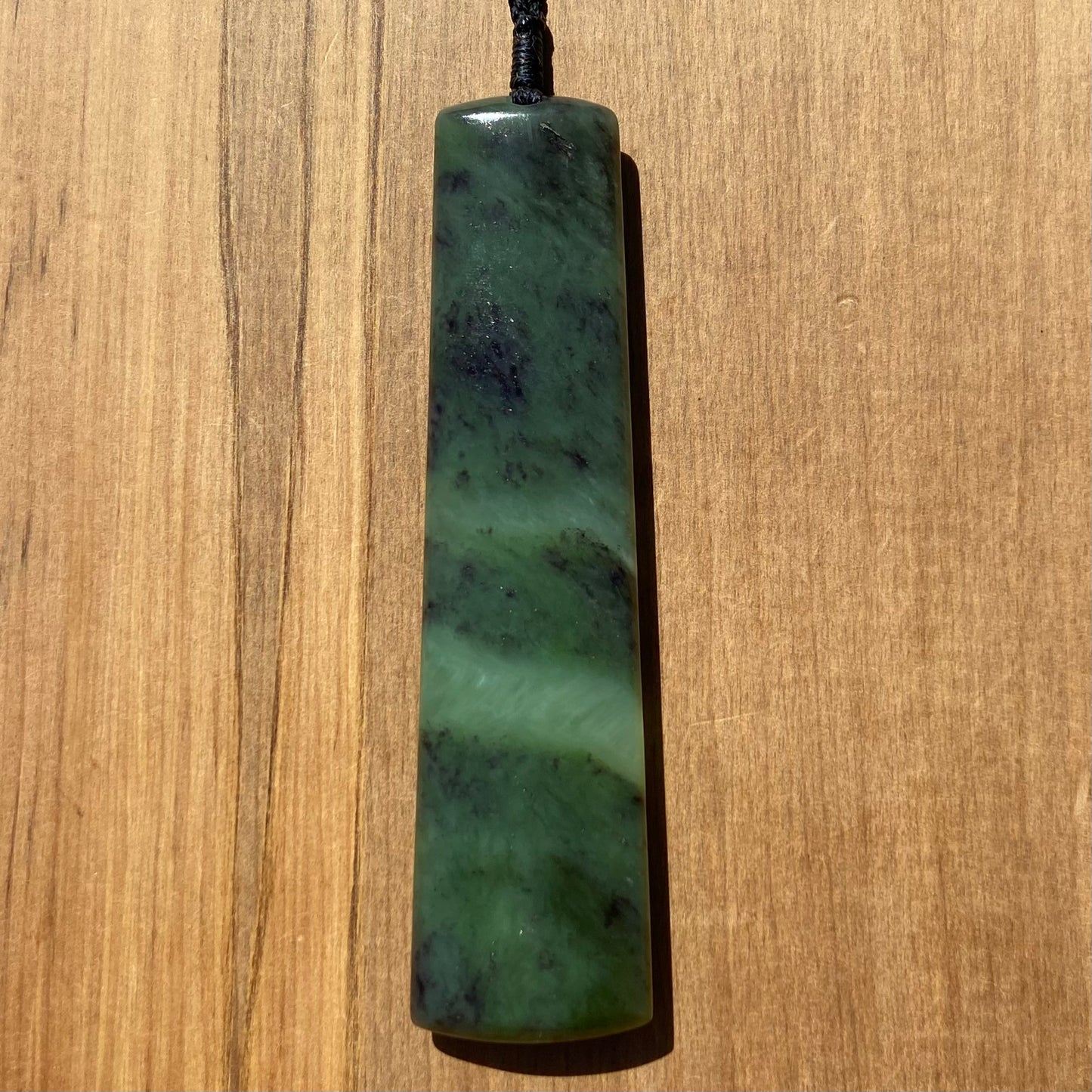 Toki pendant hand-carved from New Zealand totoweka pounamu (greenstone). Front.