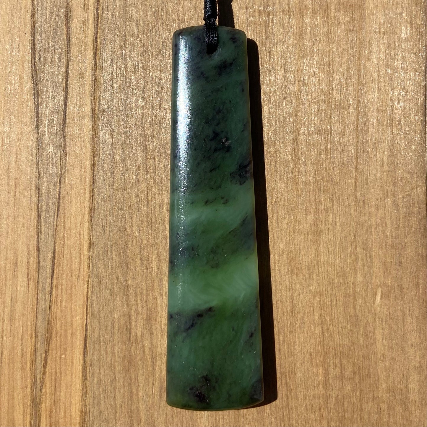 Toki pendant hand-carved from New Zealand totoweka pounamu (greenstone). Back.