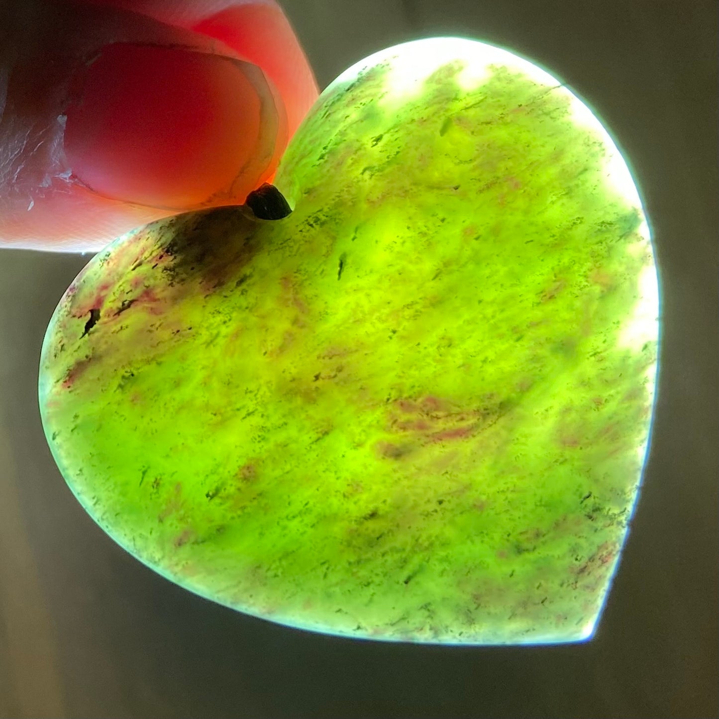 Heart pendant hand-carved from New Zealand totoweka pounamu (greenstone). Translucency.