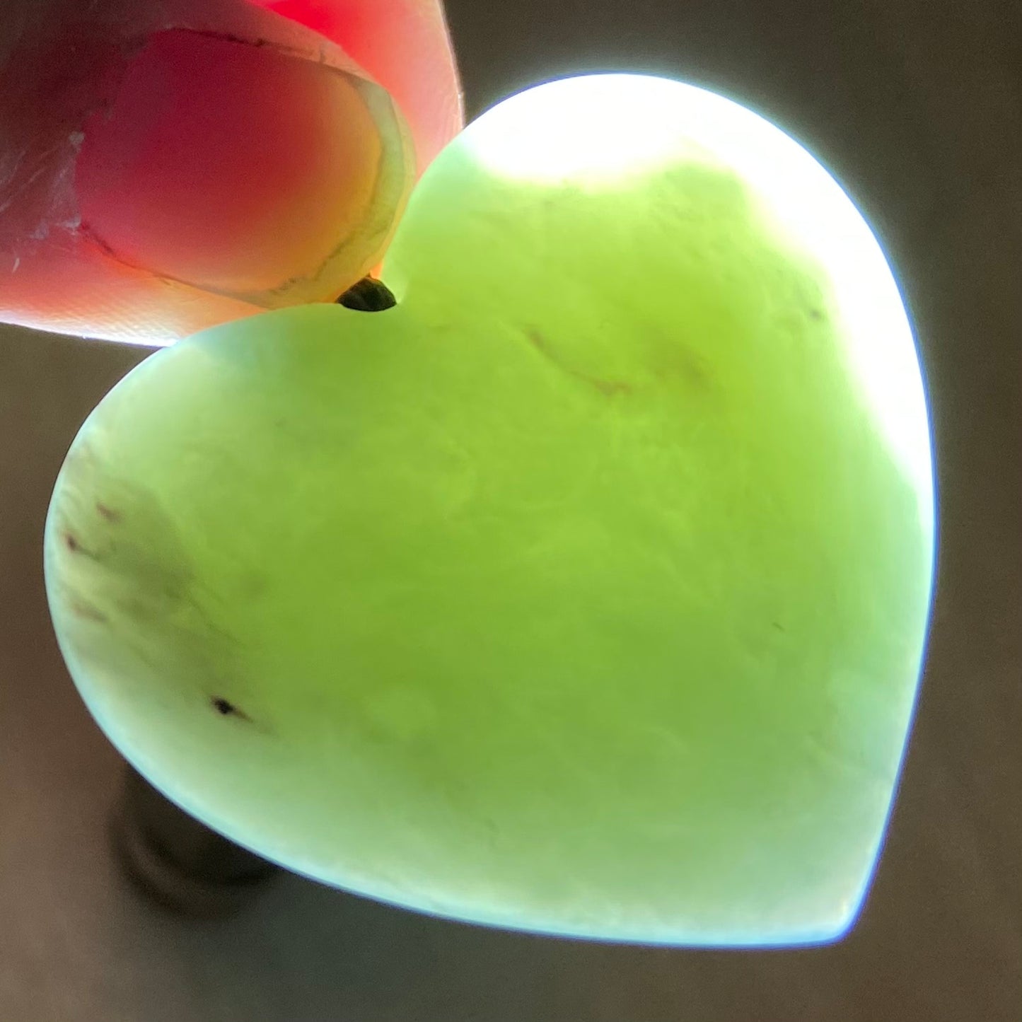 Heart shaped pendant hand-carved from New Zealand inanga pounamu (greenstone). Translucency.